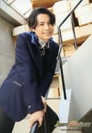 SixTONES / Hokuto Matsumura / Above-the-knee ・ Costume black, blue and white ・ Facing right ・ Handrail with both hands ・ Staircase / "JOHNNYS' King & Prince Island" original photo